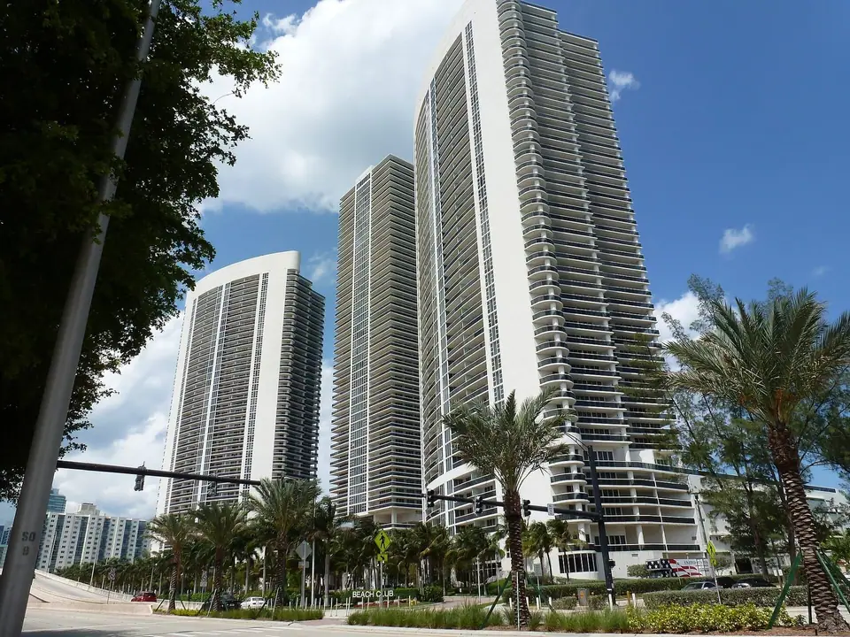The Beach Club towers and palms on South Ocean Drive in Hallandale Beach, FL