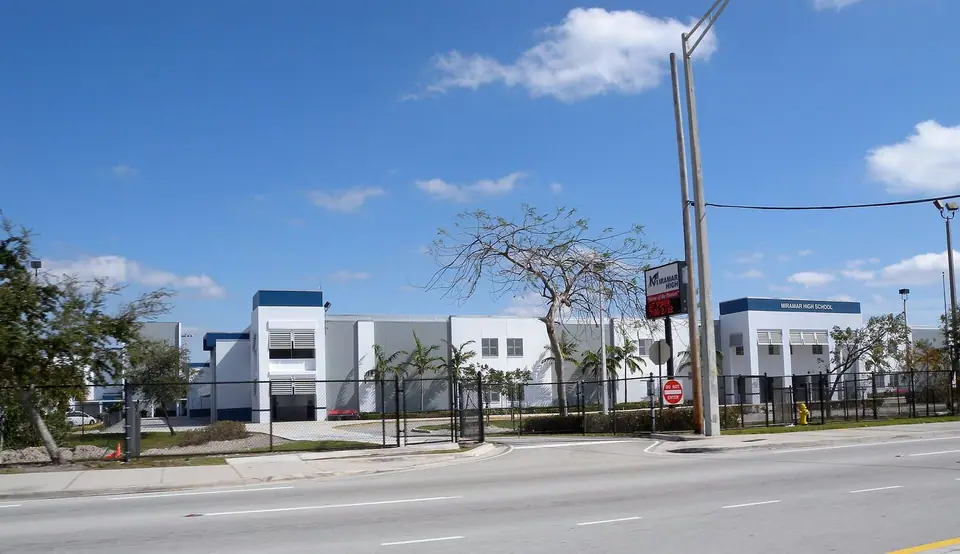 Miramar High School on a wide road under blue sky in Miramar, FL